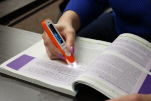 A C-Pen Reader being used to read a textbook.