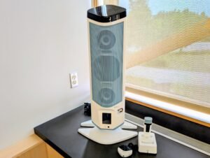 A Front Row Juno System speaker, microphone next to a window.